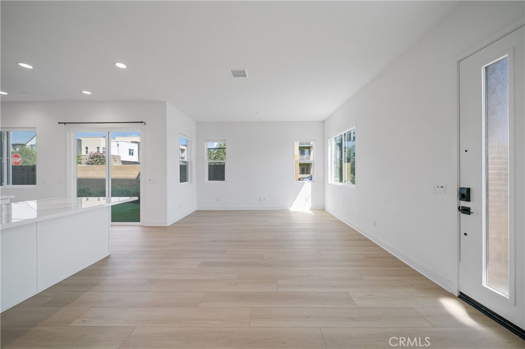 187 Yugen Irvine, CA 92618 - Photo 5 of 31 an empty room with wooden floor and windows