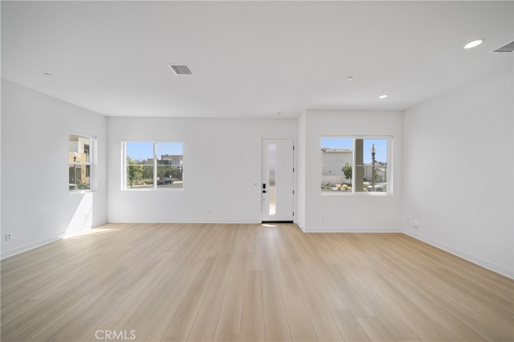 187 Yugen Irvine, CA 92618 - Photo 6 of 31 a view of an empty room with a window and wooden floor