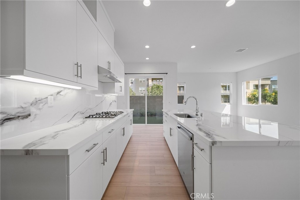 187 Yugen Irvine, CA 92618 - Photo 7 of 31 a large kitchen with granite countertop a sink and cabinets