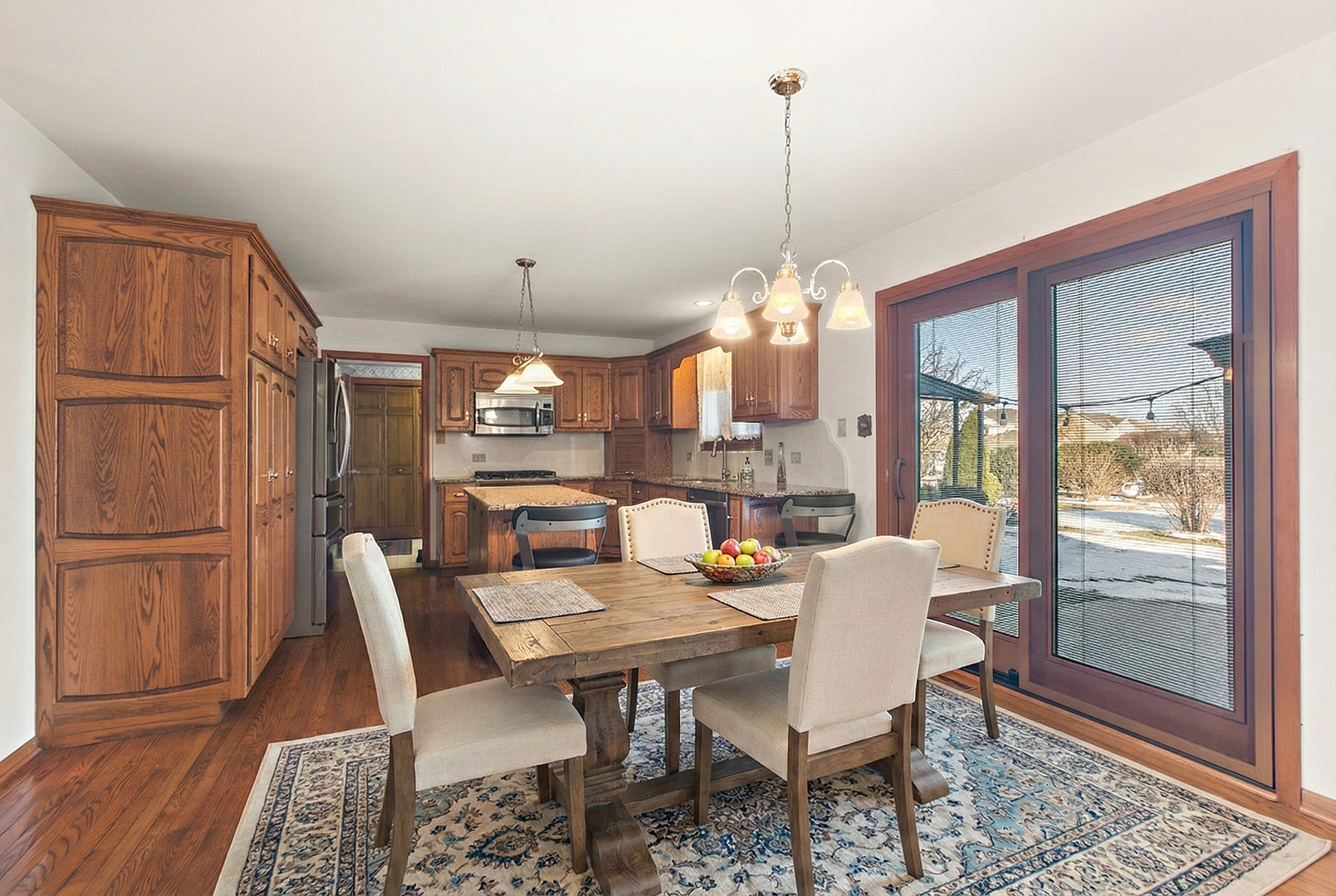 16221 Kingsport Road Orland Park, IL 60467 - Photo 16 of 58 a dining room with furniture a chandelier and wooden floor