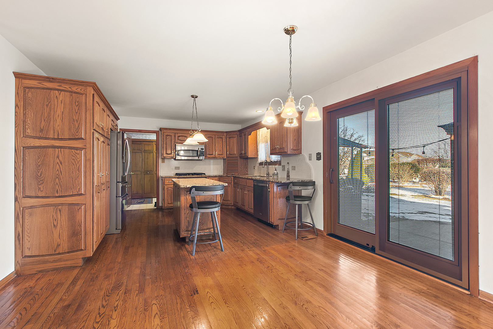 16221 Kingsport Road Orland Park, IL 60467 - Photo 17 of 58 a view of a kitchen with wooden floor and a window