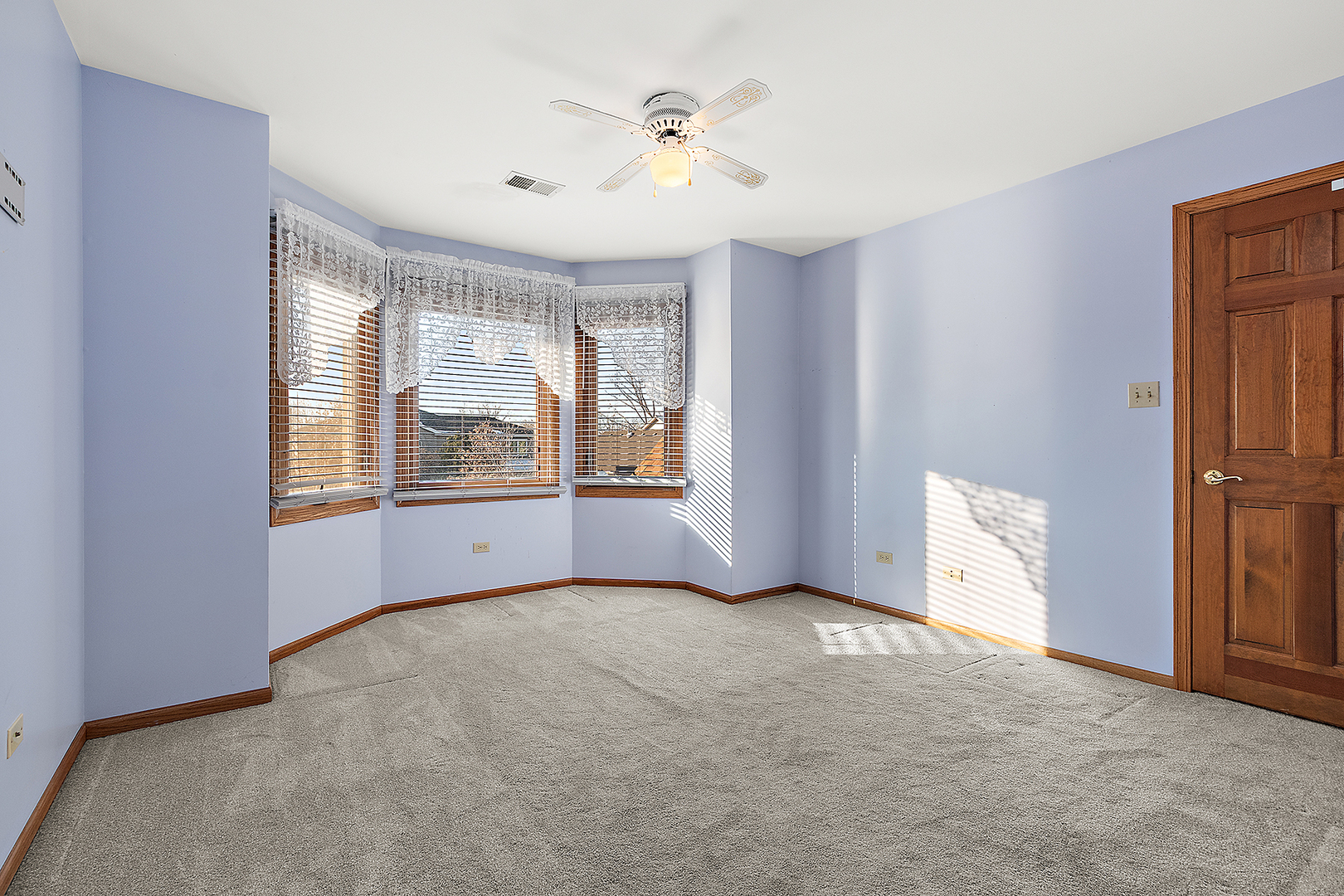 16221 Kingsport Road Orland Park, IL 60467 - Photo 36 of 58 an empty room with windows and chandelier fan