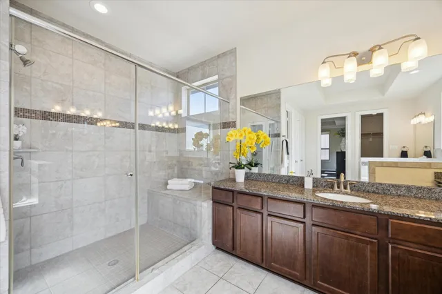 an empty room with wooden floor ceiling fan and windows