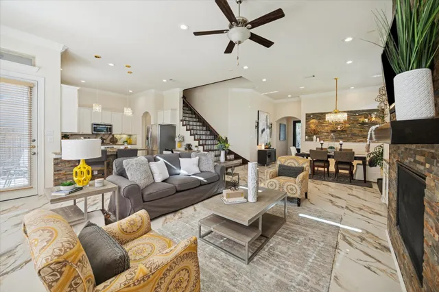 a living room with furniture a flat screen tv and a fireplace