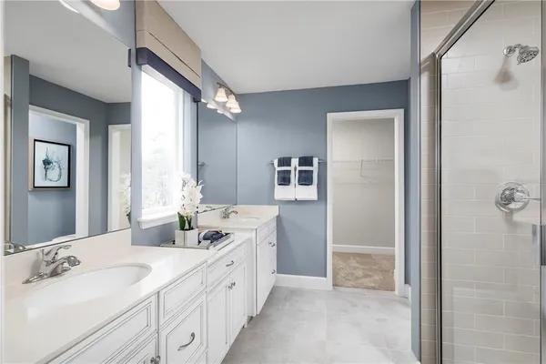 a spacious bathroom with a double vanity sink mirror and double