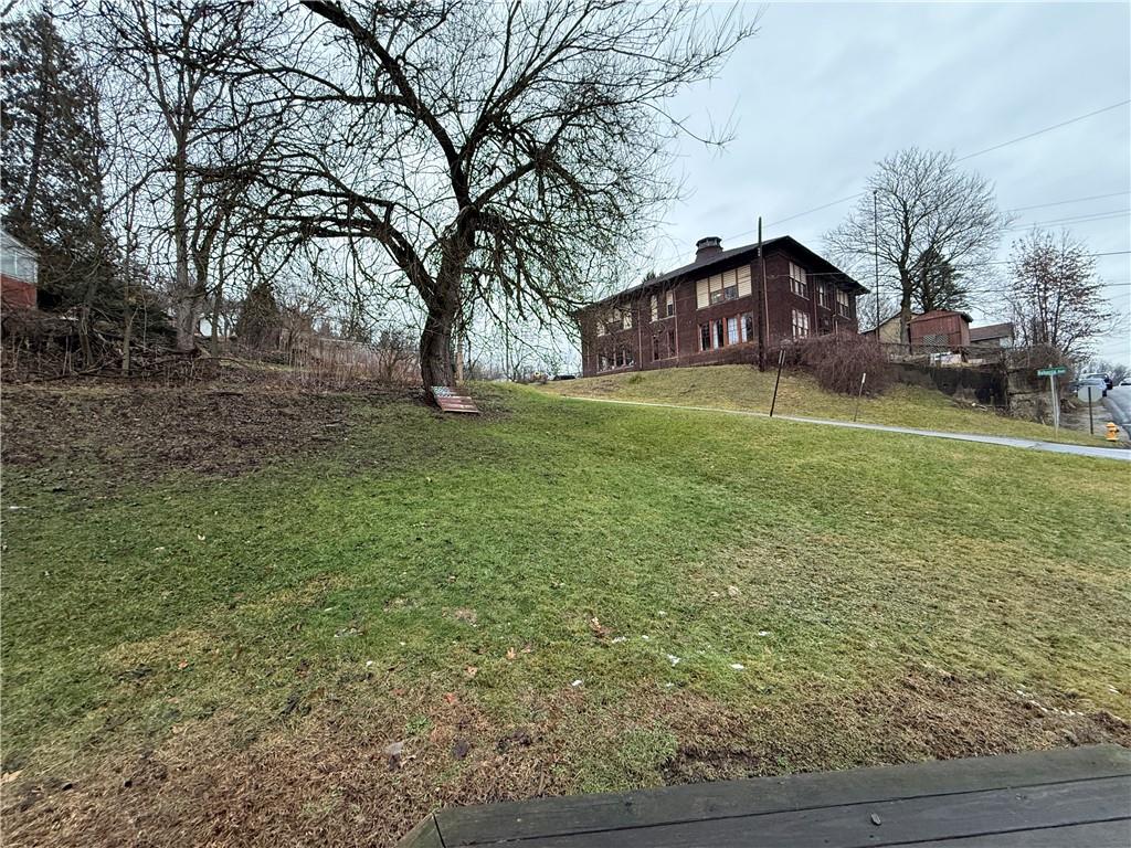 727 Thompson Street Turtle Creek, PA 15145 - Photo 21 of 25 a front view of a house with a yard