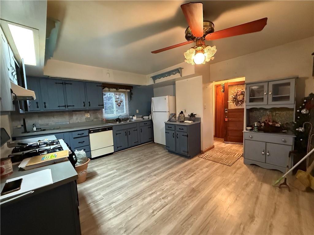 727 Thompson Street Turtle Creek, PA 15145 - Photo 7 of 25 a kitchen with stainless steel appliances granite countertop a stove refrigerator and cabinets