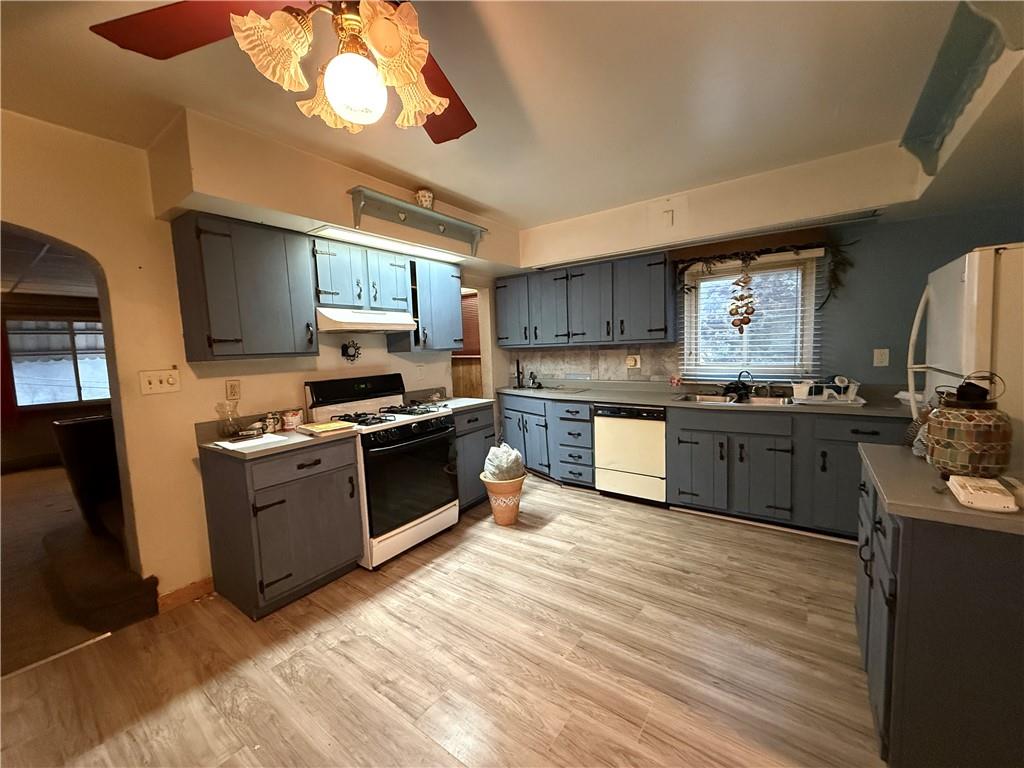 727 Thompson Street Turtle Creek, PA 15145 - Photo 8 of 25 a kitchen with stainless steel appliances granite countertop a stove a sink and a refrigerator