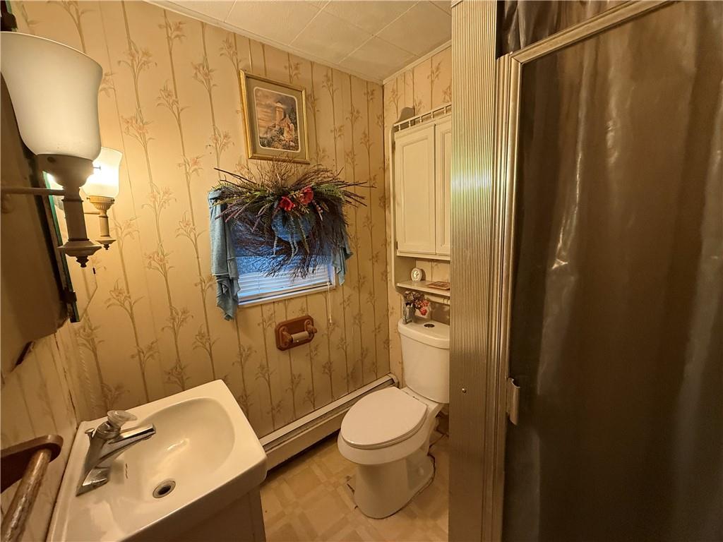 727 Thompson Street Turtle Creek, PA 15145 - Photo 9 of 25 a bathroom with a toilet a sink and shower