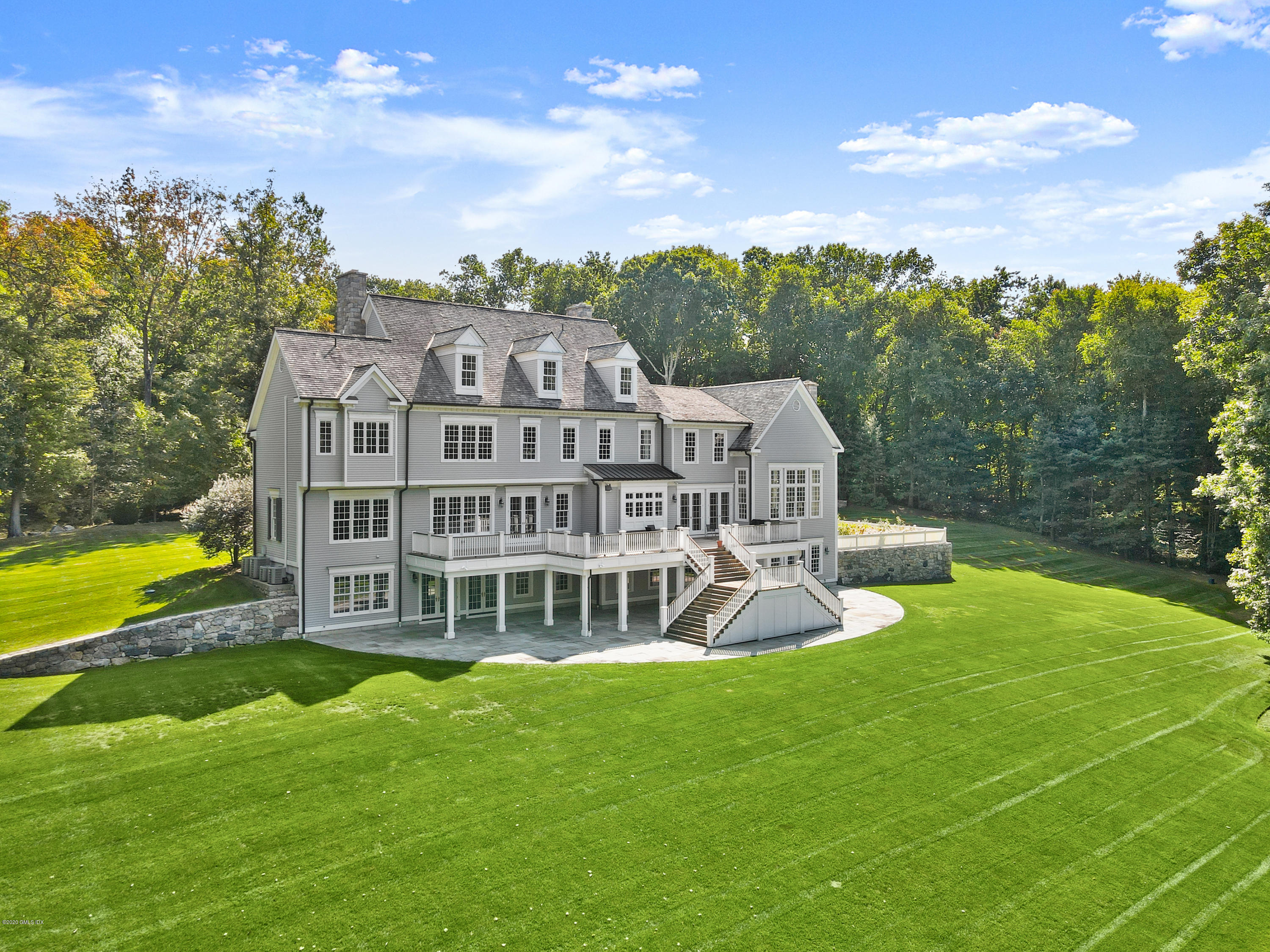 70 Old Mill Road Greenwich, CT 06831 - Photo 15 of 20 a view of a house with a big yard and large trees