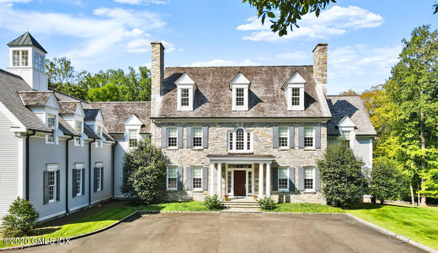 70 Old Mill Road Greenwich, CT 06831 - Photo 3 of 20 a front view of a house with a garden and plants