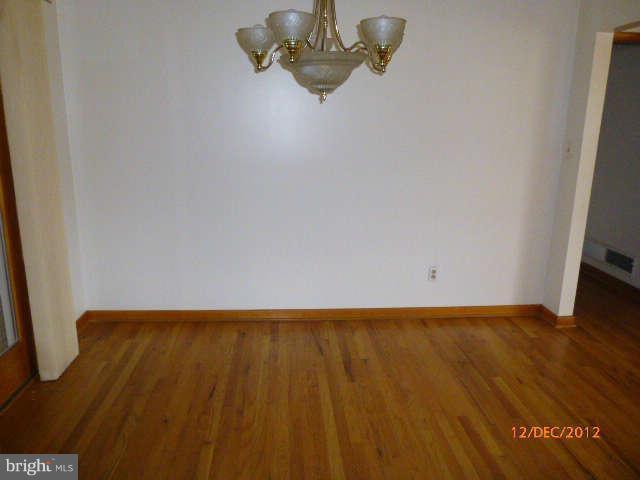 3945 Salem Bottom Road Westminster, MD 21157 - Photo 3 of 11 a view of an empty room with wooden floor