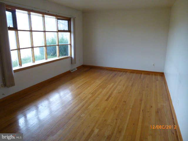 3945 Salem Bottom Road Westminster, MD 21157 - Photo 4 of 11 a view of an empty room and wooden floor