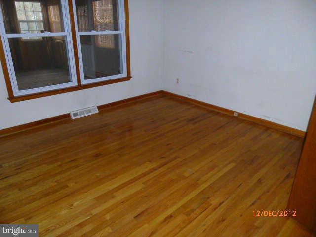 3945 Salem Bottom Road Westminster, MD 21157 - Photo 8 of 11 a view of an empty room with wooden floor and a window