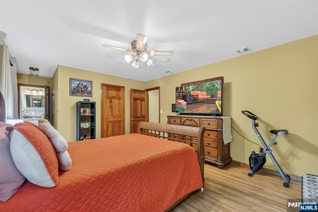 5110 Berkshire Valley Road Oak Ridge, NJ 07438 - Photo 30 of 49 a bedroom with a bed and a flat screen tv
