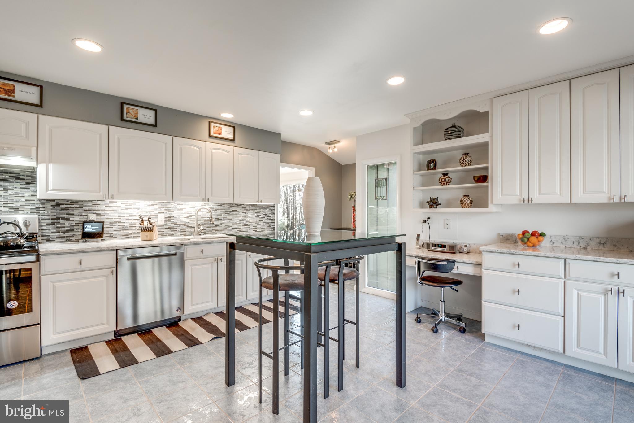 11401 Drop Forge Lane Reston, VA 20191 - Photo 14 of 38 a kitchen with granite countertop white cabinets and white appliances