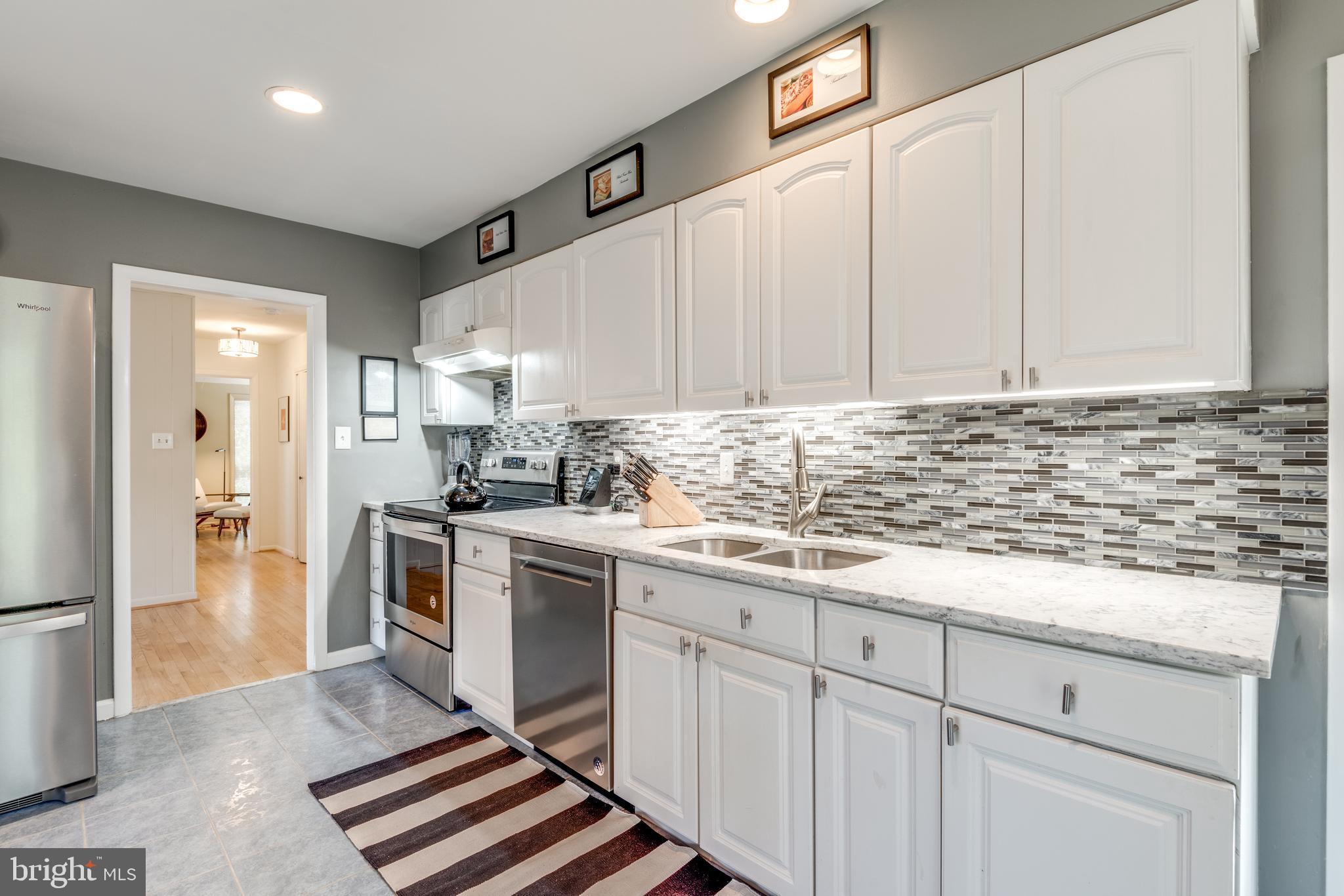11401 Drop Forge Lane Reston, VA 20191 - Photo 16 of 38 a kitchen with granite countertop a sink stainless steel appliances and cabinets