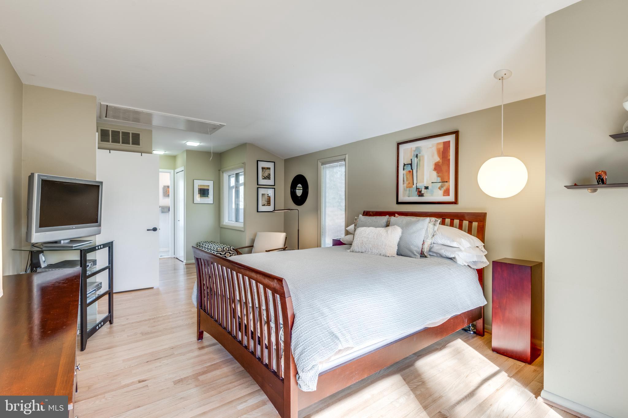 11401 Drop Forge Lane Reston, VA 20191 - Photo 18 of 38 a bedroom with a bed and a flat screen tv