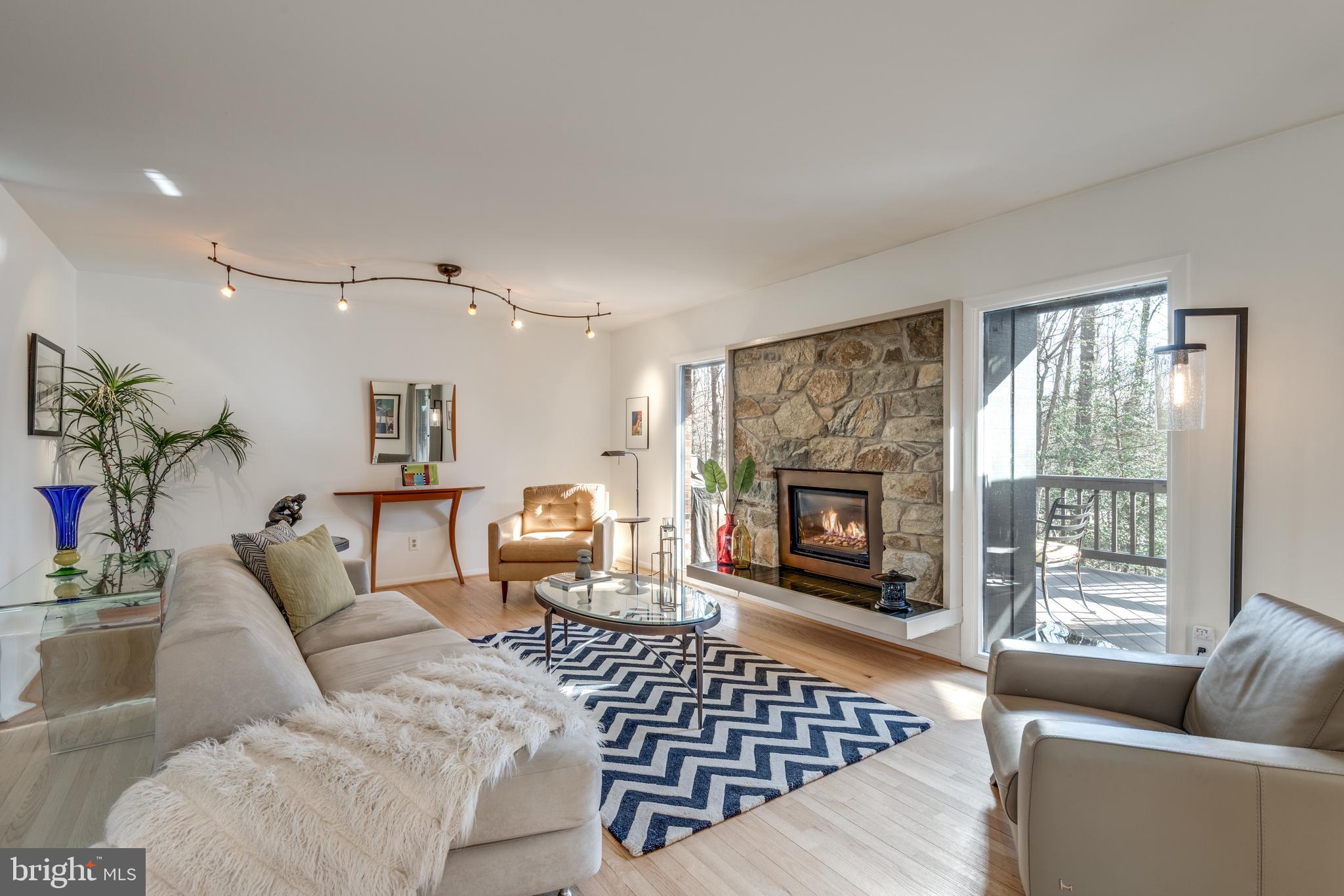 11401 Drop Forge Lane Reston, VA 20191 - Photo 5 of 38 a living room with furniture a large window and a fireplace