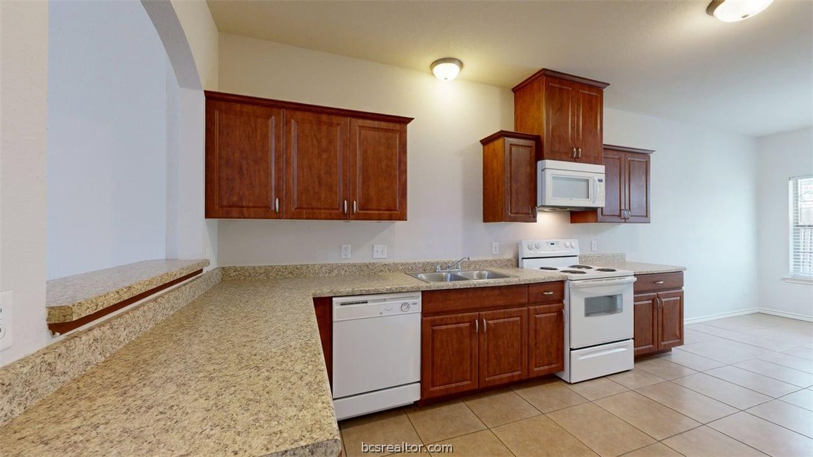 4453-4455 Reveille Road College Station, TX 77845 - Photo 23 of 37 a kitchen with a stove and a sink