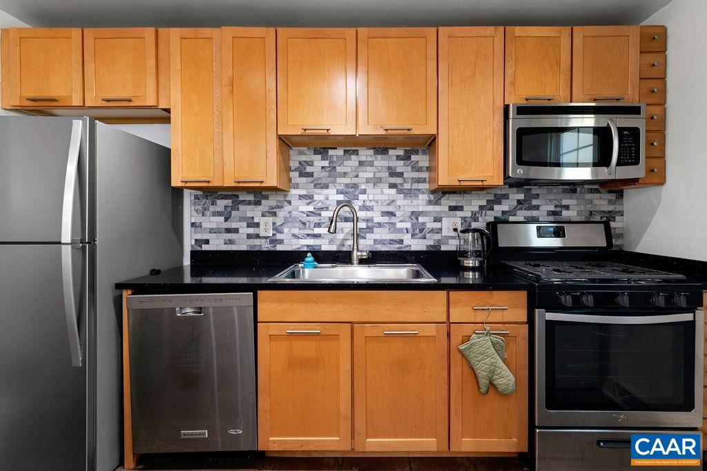 114 Hessian Hills Ridge, Unit 1 Charlottesville, VA 22901 - Photo 8 of 20 a kitchen with stainless steel appliances granite countertop a stove microwave refrigerator and sink