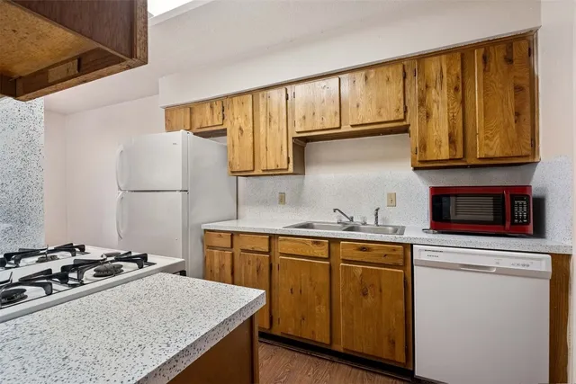 a kitchen with a sink stove and refrigerator