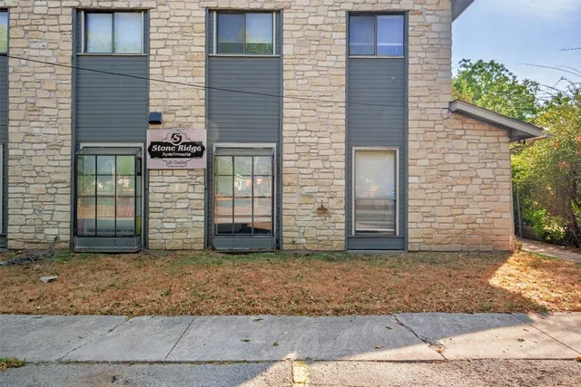 a view of a house with an empty space and garage
