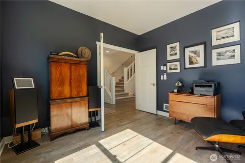 a kitchen with white cabinets and sink