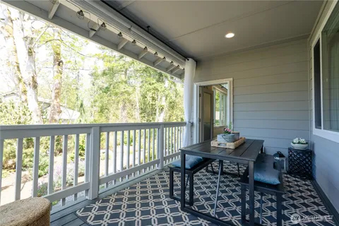 a view of a house with a yard and sitting area