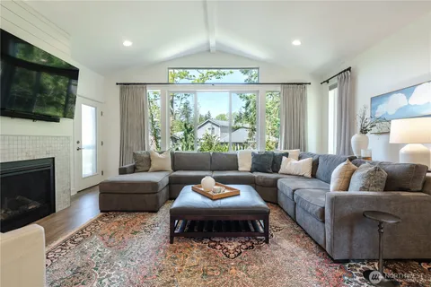 a living room with furniture fireplace and flat screen tv