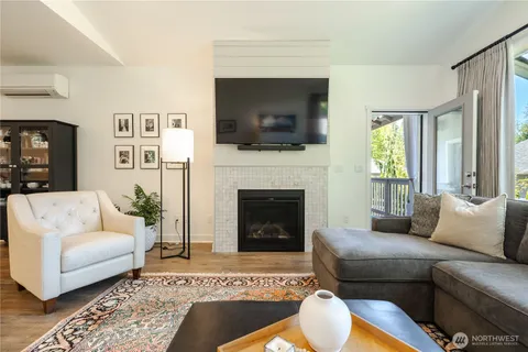 a living room with furniture fireplace and flat screen tv