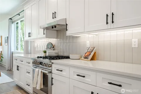 a kitchen with stainless steel appliances a sink and cabinets