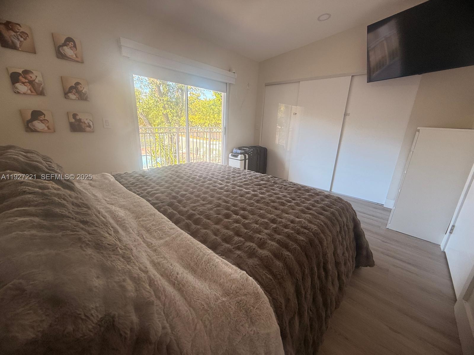 6864 Northwest 166th Terrace, Unit 903 Miami Lakes, FL 33014 - Photo 12 of 29 a bedroom with a bed and a window