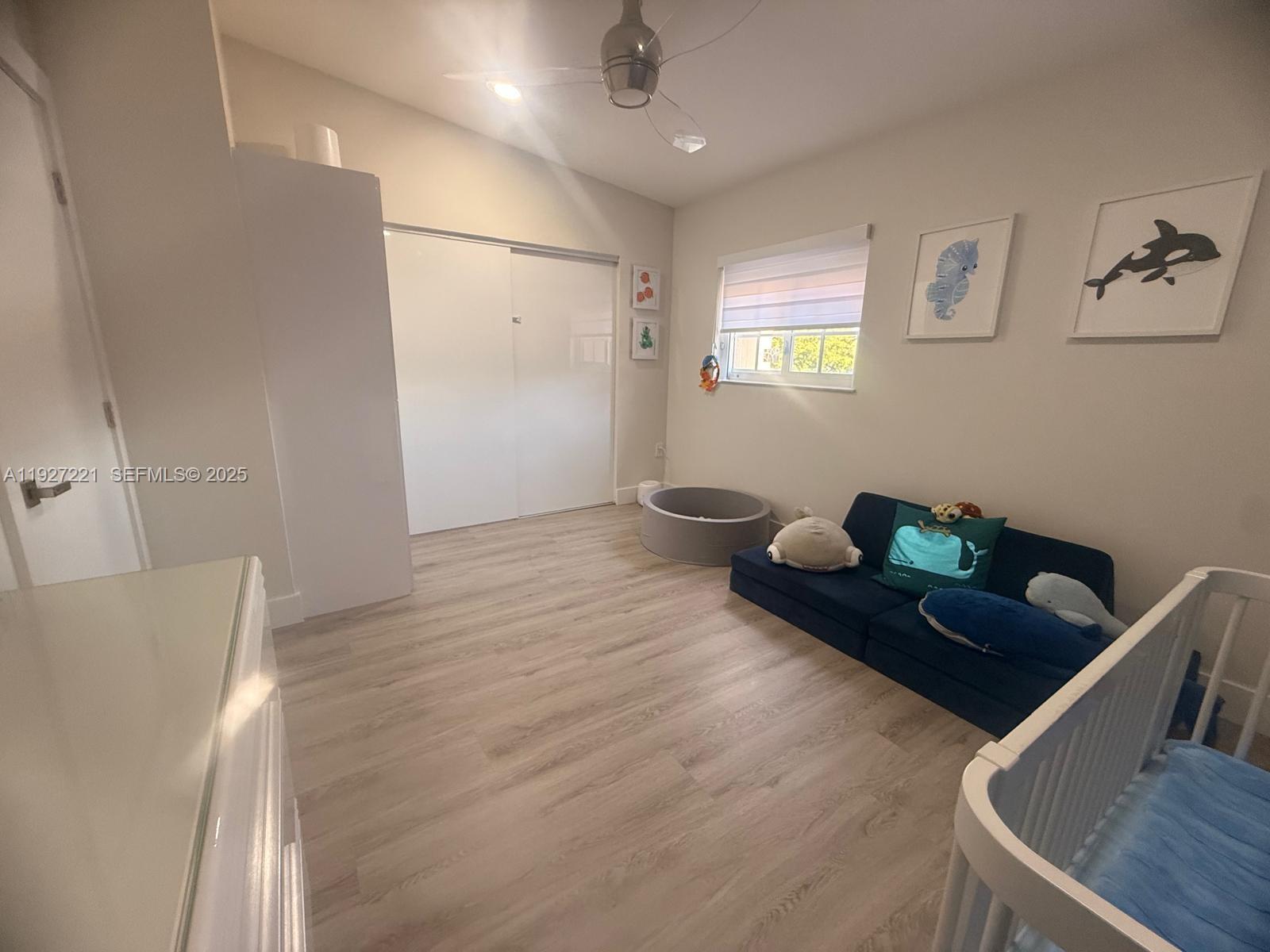 6864 Northwest 166th Terrace, Unit 903 Miami Lakes, FL 33014 - Photo 13 of 29 a room with wooden floor and furniture