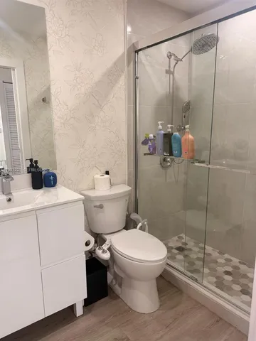 a bathroom with a toilet sink and a shower