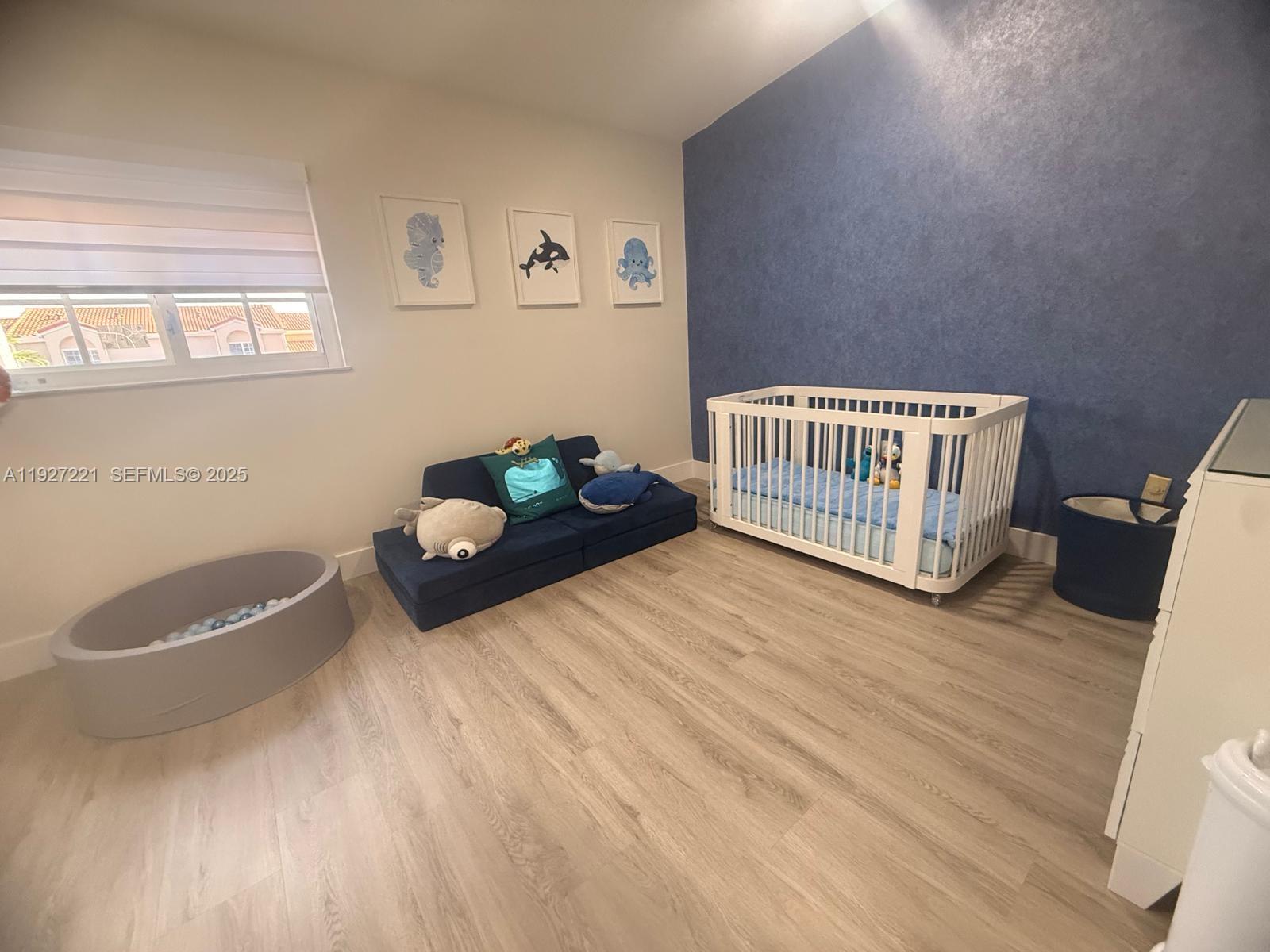 6864 Northwest 166th Terrace, Unit 903 Miami Lakes, FL 33014 - Photo 17 of 29 a bedroom with a bed and a window