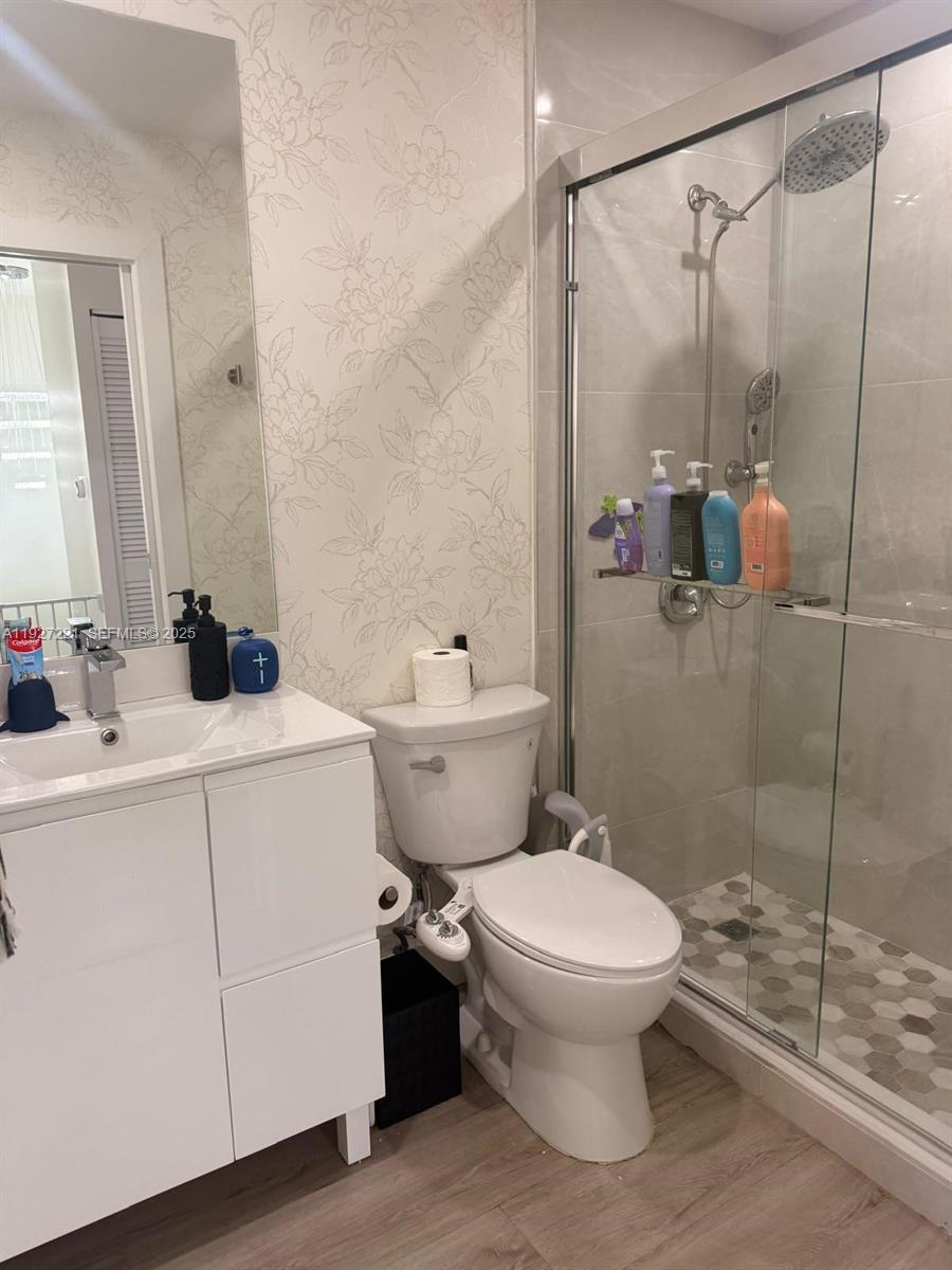 6864 Northwest 166th Terrace, Unit 903 Miami Lakes, FL 33014 - Photo 27 of 29 a bathroom with a sink toilet and shower