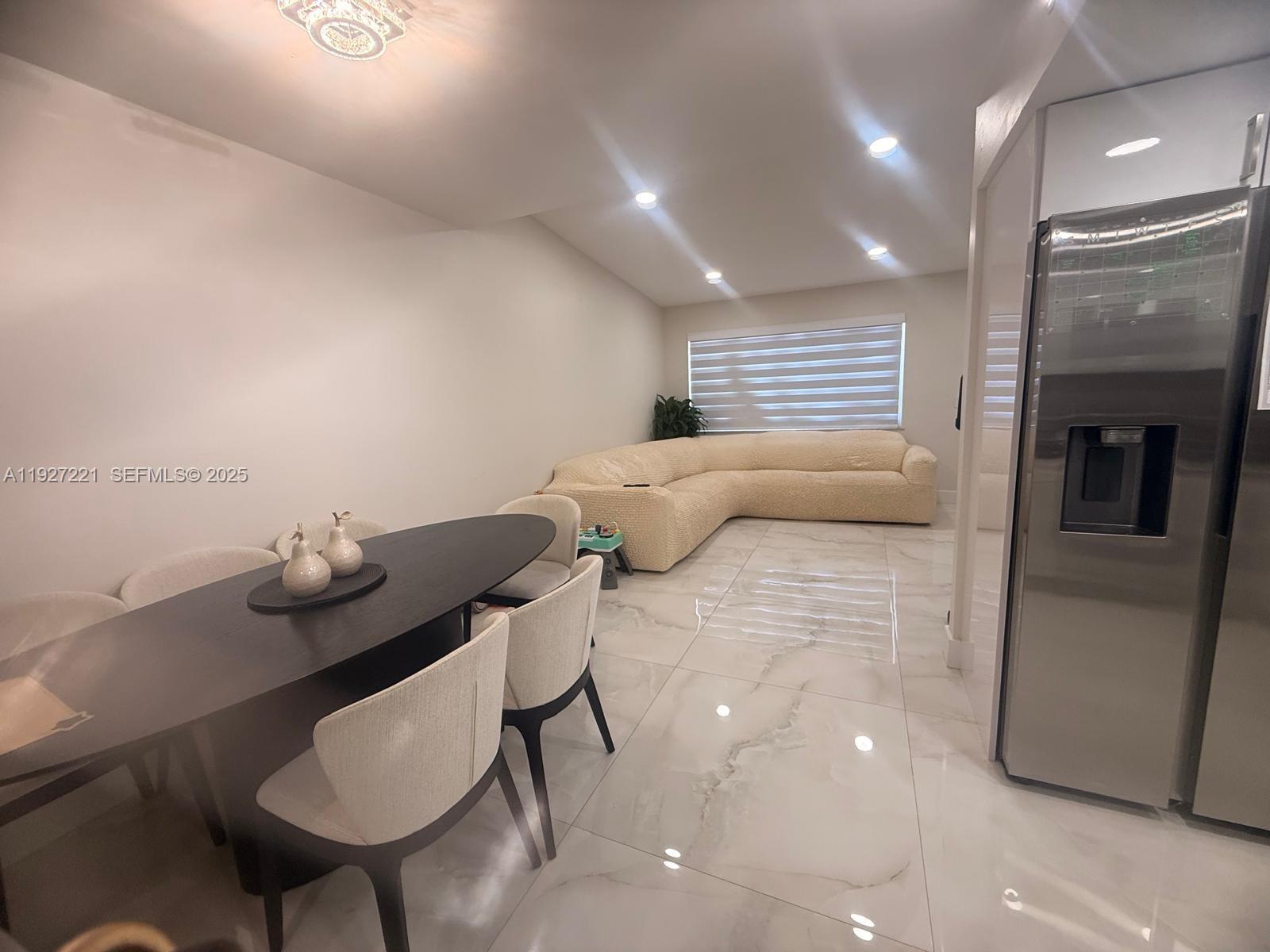 6864 Northwest 166th Terrace, Unit 903 Miami Lakes, FL 33014 - Photo 7 of 29 a living room with furniture and a window