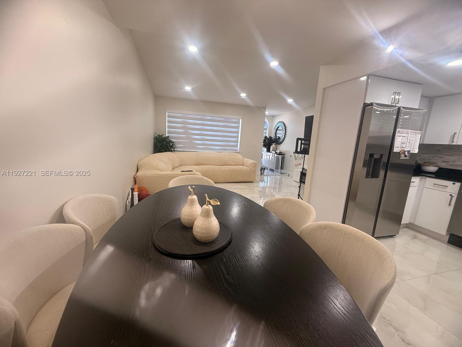 6864 Northwest 166th Terrace, Unit 903 Miami Lakes, FL 33014 - Photo 8 of 29 a living room with furniture