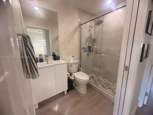 a bathroom with a toilet sink and a shower