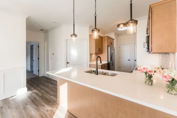 a kitchen with stainless steel appliances a stove microwave and cabinets