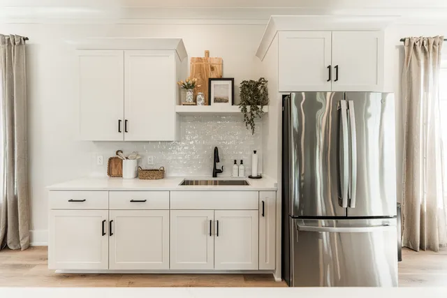 a kitchen with appliances cabinets and a refrigerator