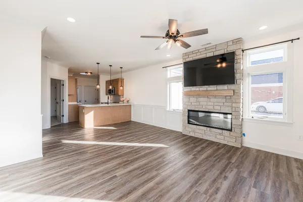 a view of a kitchen with wooden floor and a ceiling fan