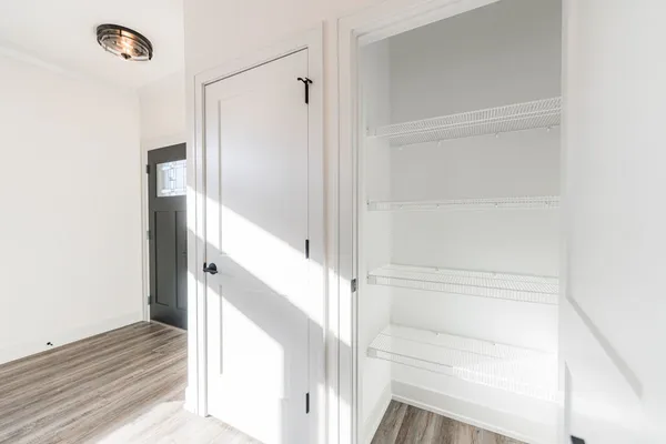 a kitchen with stainless steel appliances granite countertop a sink a stove and a wooden floors