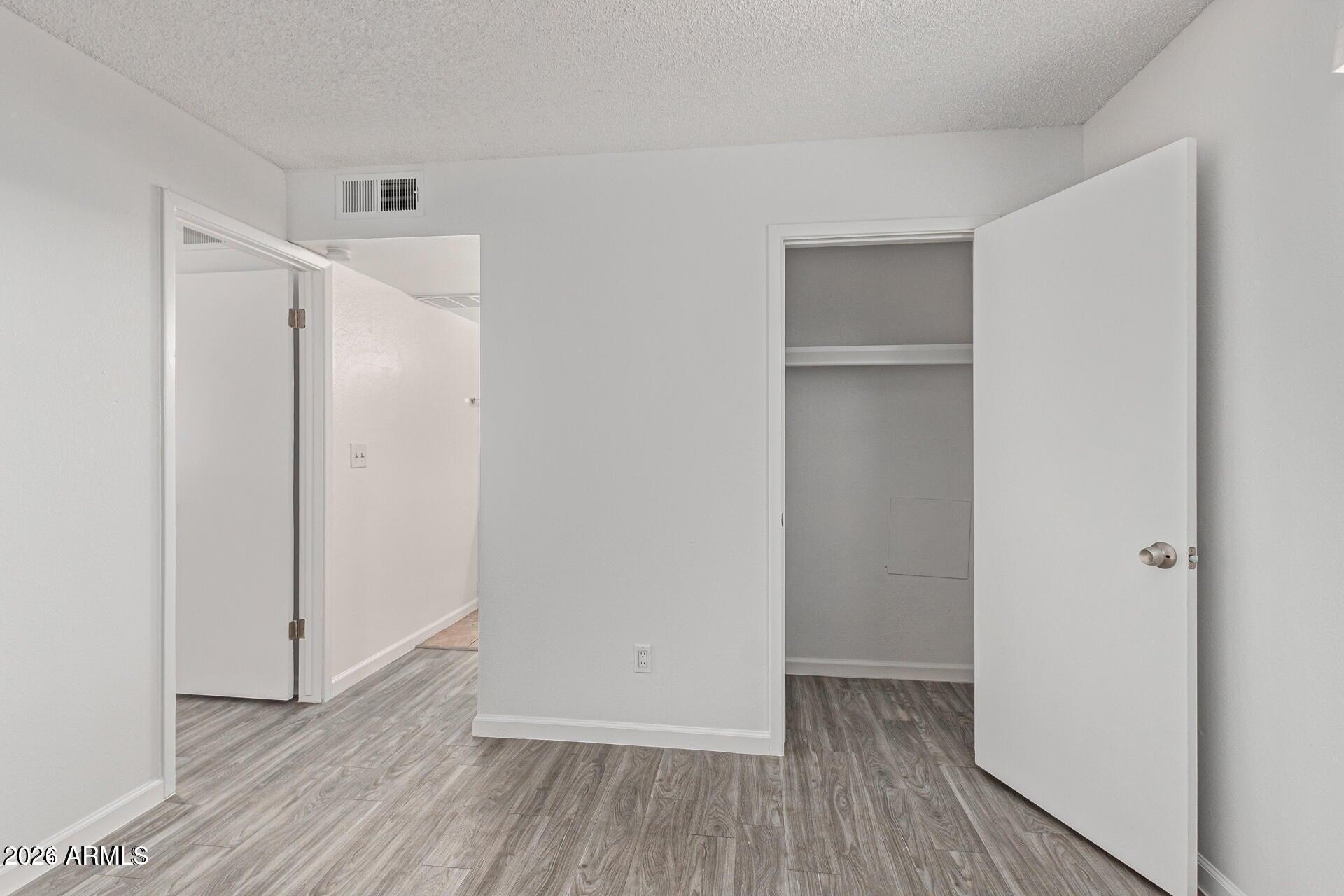 1029 South Wilson Street, Unit 14 Tempe, AZ 85281 - Photo 7 of 12 a view of an empty room with wooden floor