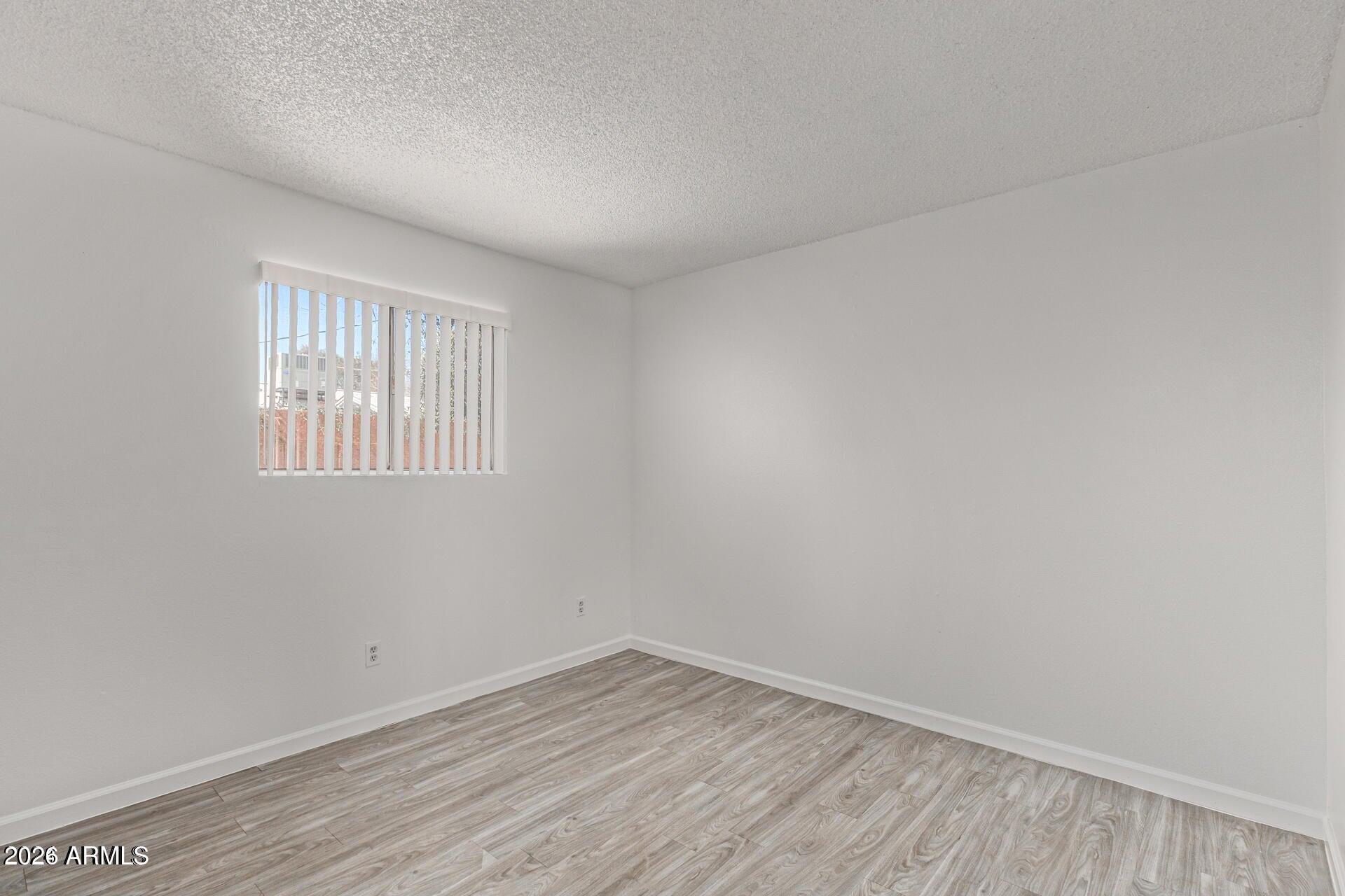 1029 South Wilson Street, Unit 14 Tempe, AZ 85281 - Photo 9 of 12 wooden floor in an empty room