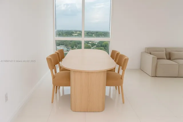 a dining room with furniture and a window