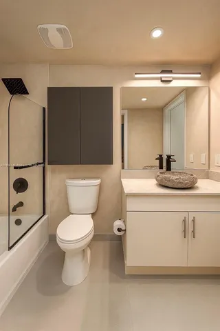 a bathroom with a toilet a sink and a mirror
