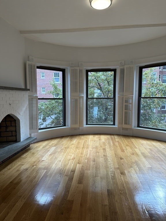 29 Bay State Road, Unit 3 Boston, MA 02215 - Photo 11 of 22 a view of an empty room with wooden floor and a window