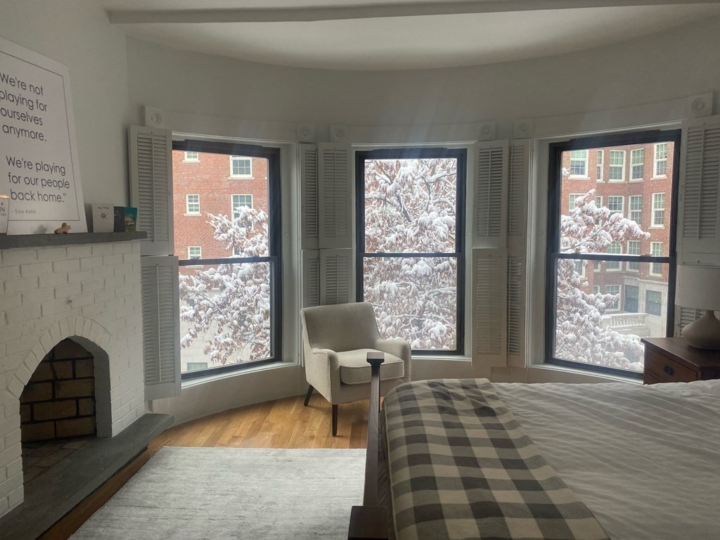 29 Bay State Road, Unit 3 Boston, MA 02215 - Photo 13 of 22 a living room with furniture and a fireplace